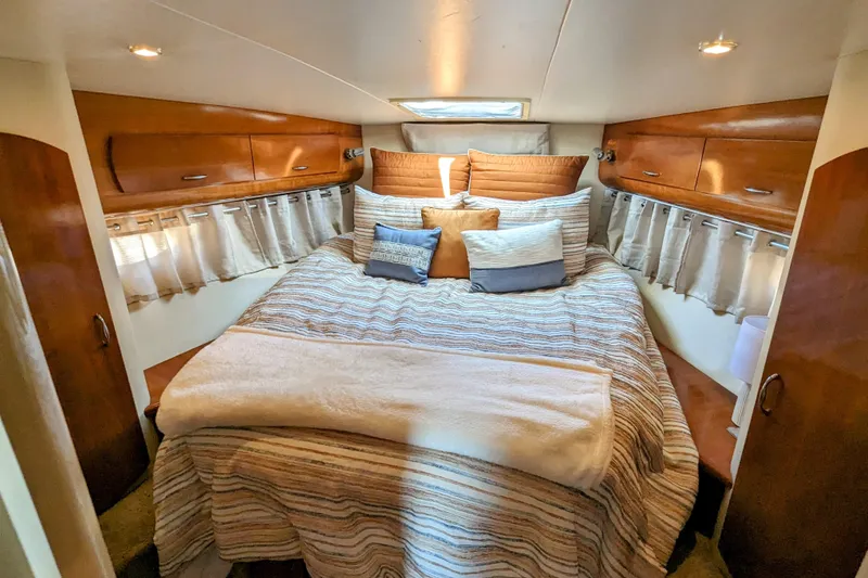 Slide: The Image of Luxurious 2004 Carver 360 Mariner cabin with cozy bed and elegant wood finishes. - 4