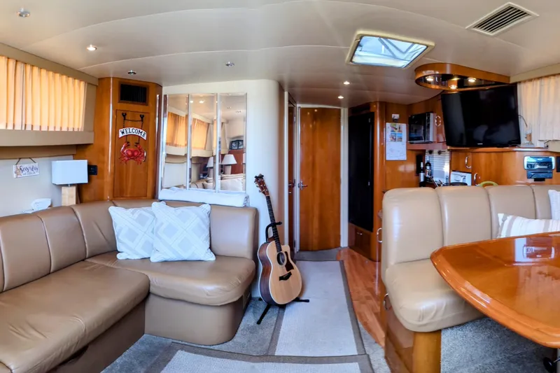 Slide: The Image of Interior of 2004 Carver 360 Mariner yacht with cozy seating and guitar. - 5