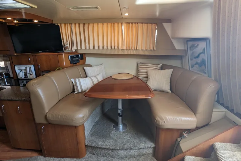 Slide: The Image of Interior of 2004 Carver 360 Mariner yacht with cozy dining area and plush seating. - 6