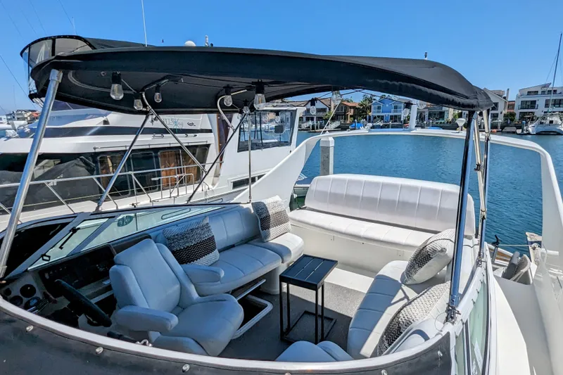 Slide: The Image of 2004 Carver 360 Mariner yacht with spacious seating and canopy, docked in a marina. - 9