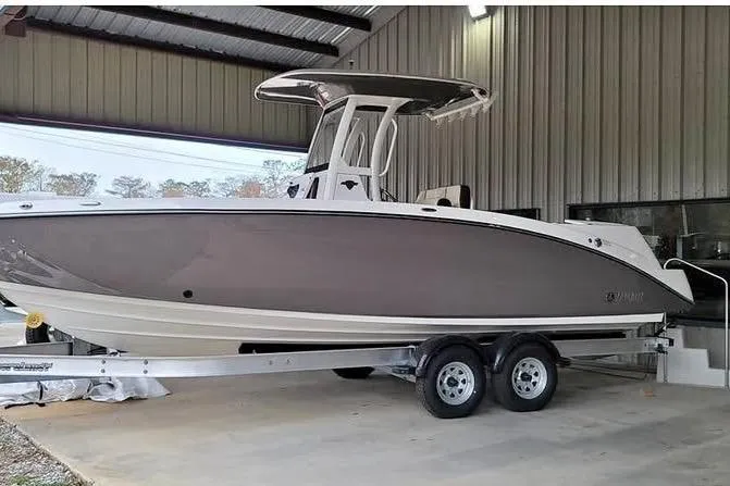 The Image of 2022 Yamaha Boats 252 FSH Sport on trailer in covered storage area. - 1