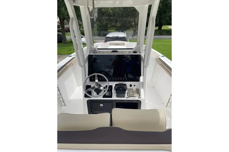 Slide: The Image of 2022 Yamaha Boats 252 FSH Sport dashboard with steering wheel and controls. - 9