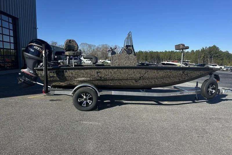 The Image of 2026 Xpress H190B Bay boat on trailer, parked outdoors under clear blue sky. - 0