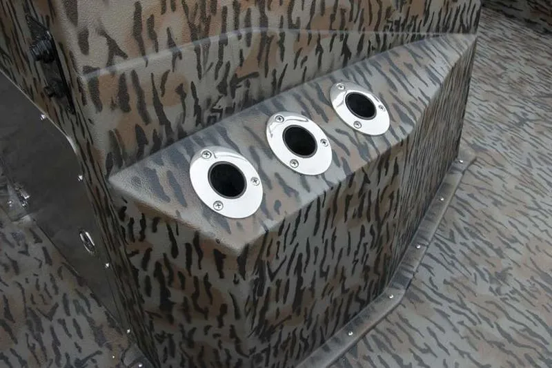 Slide: The Image of 2026 Xpress H190B Bay boat with camo pattern and three rod holders. - 16