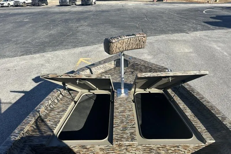 Slide: The Image of 2026 Xpress H190B Bay boat with open storage compartments and camouflage design. - 4