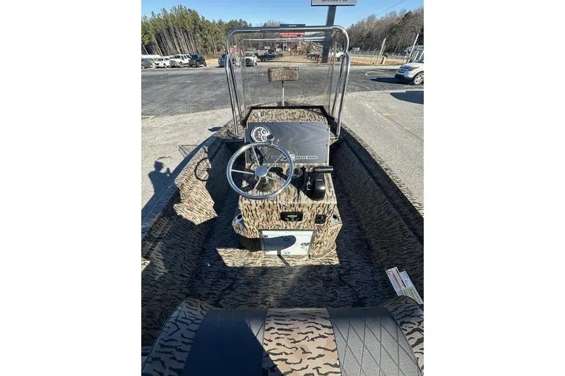 Slide: The Image of 2026 Xpress H190B Bay boat interior with camouflage design and steering console. - 5