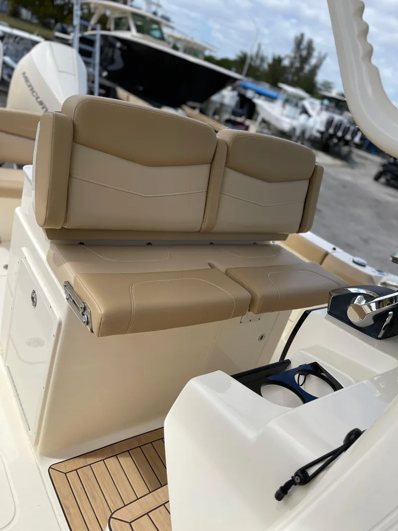 Slide: The Image of 2026 Scout 305 LXF boat with beige seats and wood accents. - 2