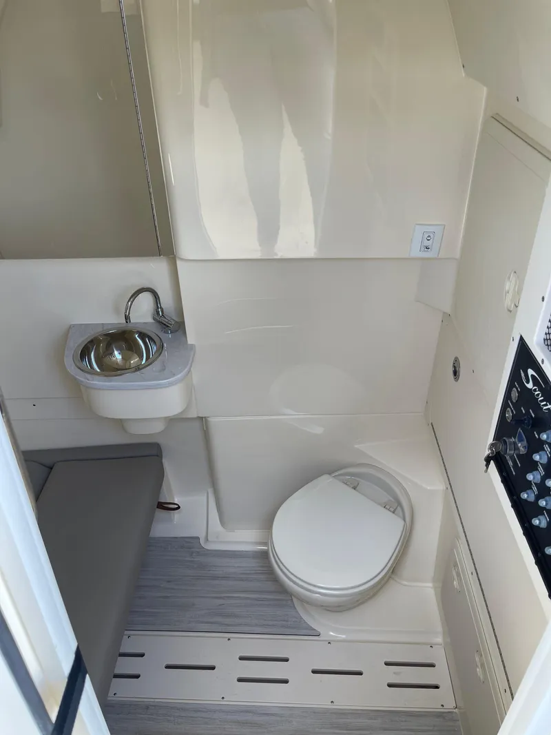 Slide: The Image of 2026 Scout 305 LXF boat interior with sink and toilet. - 9