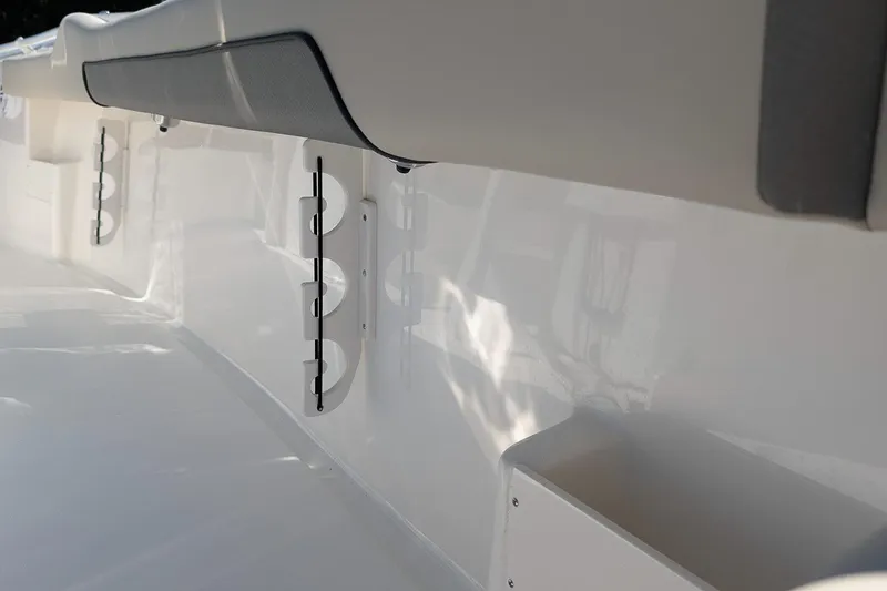 Slide: The Image of 2026 Key West 239 FS boat interior detail with rod holders and cushioned seating. - 12