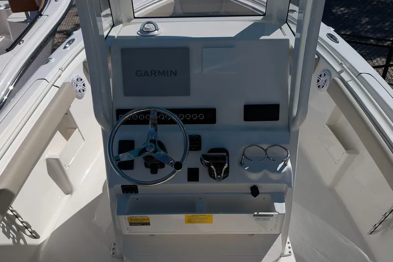 Slide: The Image of 2026 Key West 239 FS boat console with Garmin navigation, steering wheel, and controls. - 15