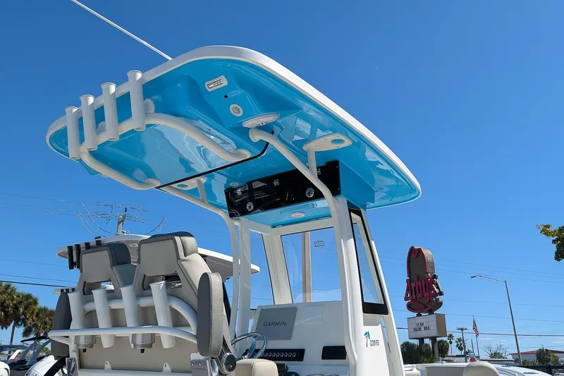 Slide: The Image of 2026 Key West 239 FS boat with blue T-top under clear sky. - 20