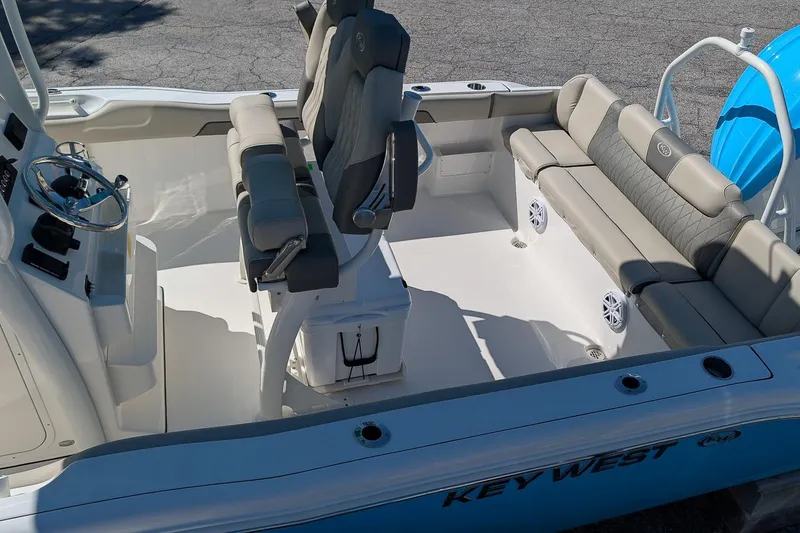 Slide: The Image of 2026 Key West 239 FS boat interior with seating and steering console. - 7