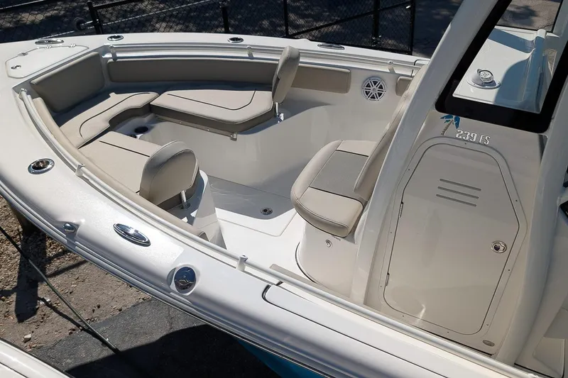 Slide: The Image of 2026 Key West 239 FS boat interior with cushioned seating and storage compartments. - 8