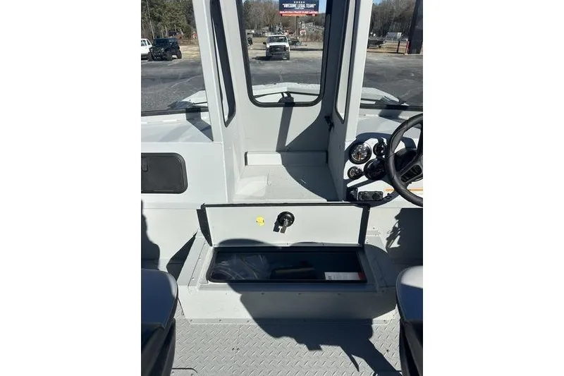 Slide: The Image of 2025 SeaArk 2072 MVT boat interior with open storage compartment and steering console. - 10