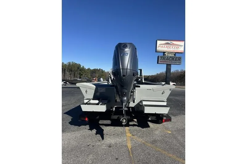 Slide: The Image of 2025 SeaArk 2072 MVT boat with powerful outboard motor, parked outdoors. - 6