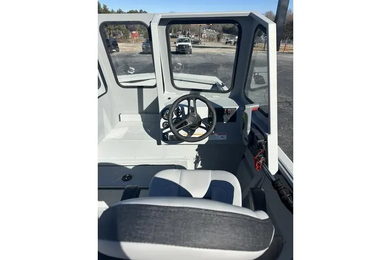 Slide: The Image of Interior view of 2025 SeaArk 2072 MVT boat, featuring steering wheel and seating. - 7