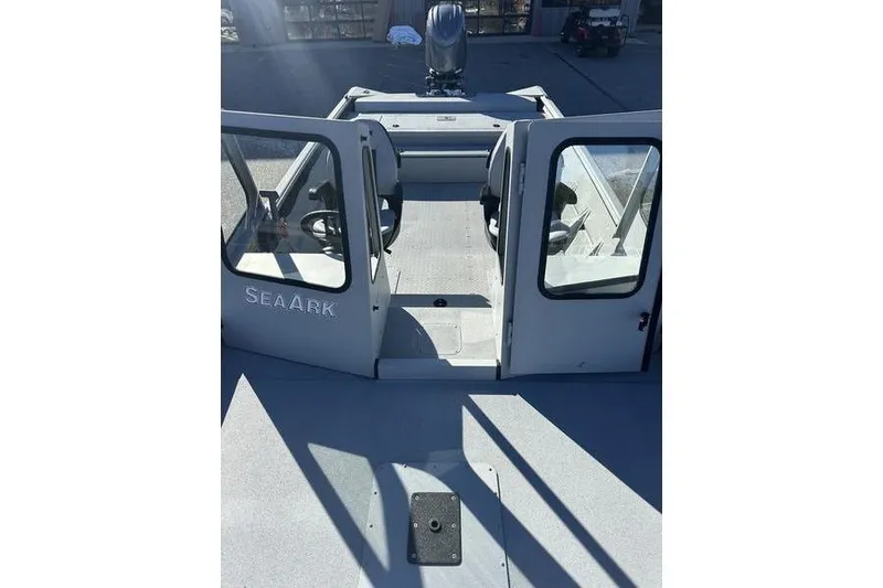 Slide: The Image of 2025 SeaArk 2072 MVT boat interior with open doors and seating. - 8