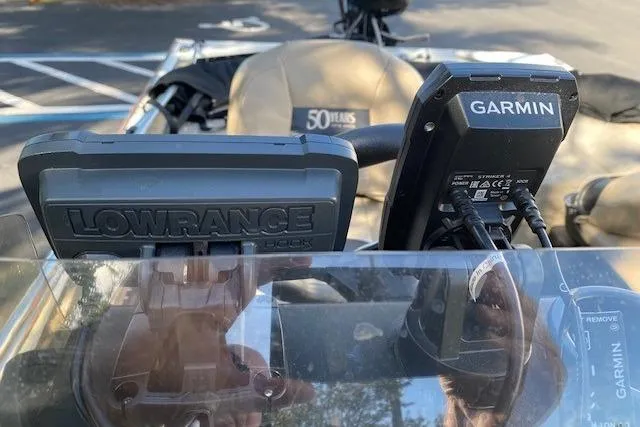 Slide: The Image of 2022 Tracker Bass Tracker Classic XL with Lowrance and Garmin fish finders on dashboard. - 11