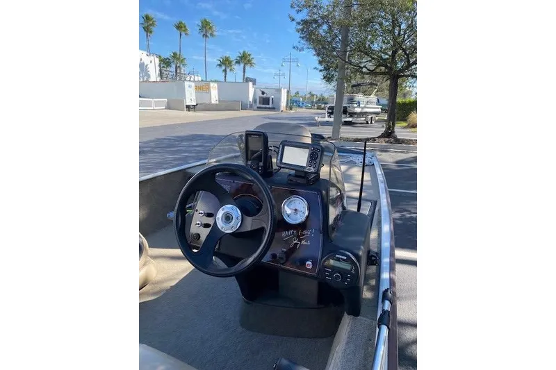 Slide: The Image of 2022 Tracker Bass Tracker Classic XL boat dashboard with steering wheel and navigation equipment. - 4