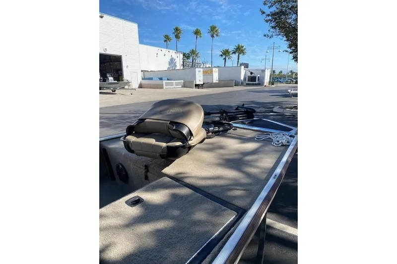 Slide: The Image of 2022 Tracker Bass Tracker Classic XL boat with folded seat, parked outdoors. - 6