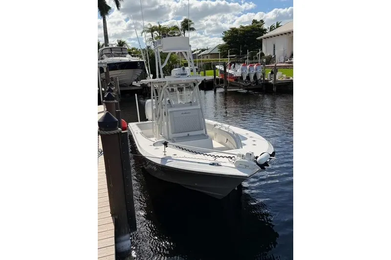 Slide: The Image of 2024 SeaHunter 28 Floridian boat docked in a marina under a partly cloudy sky. - 3