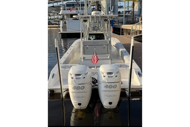 Slide: The Image of 2024 SeaHunter 28 Floridian boat with twin 400 engines docked at marina. - 4