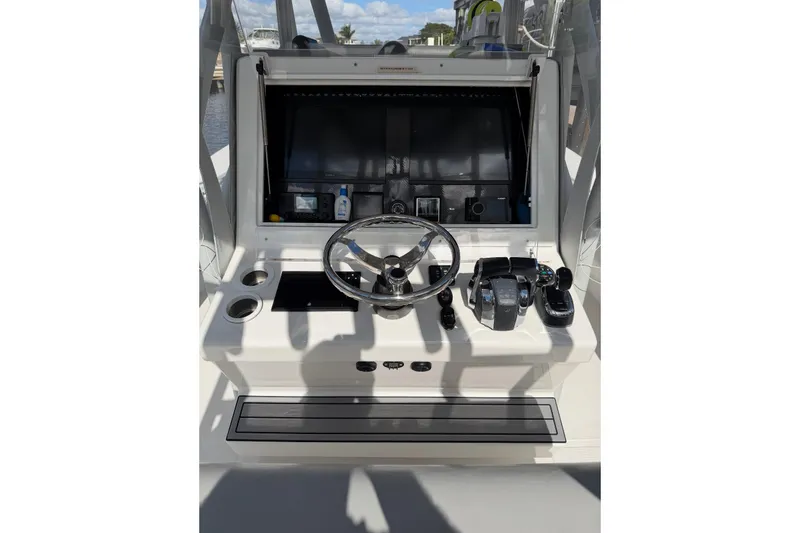 Slide: The Image of 2024 SeaHunter 28 Floridian boat console with steering wheel and controls. - 7