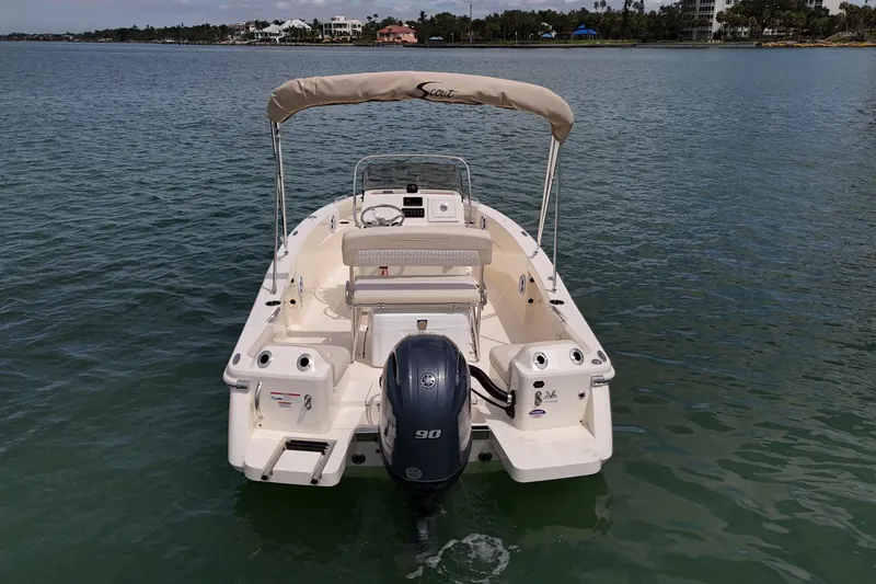 Slide: The Image of 2026 Scout 188 Sportfish boat on calm water, rear view with outboard motor. - 6