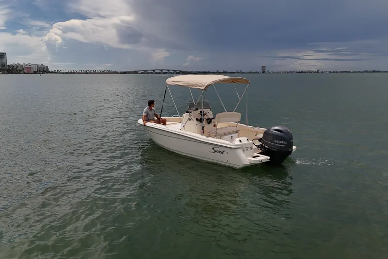 Slide: The Image of 2026 Scout 188 Sportfish boat on calm water under cloudy sky. - 7