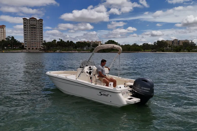 Slide: The Image of 2026 Scout 188 Sportfish boat on water with Yamaha engine, scenic background. - 9