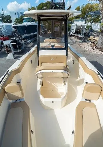 Slide: The Image of Scout 240 XSF 2026 boat with beige interior outdoors. - 3