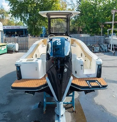 Slide: The Image of 2026 Scout 240 XSF boat on display outdoors. - 7