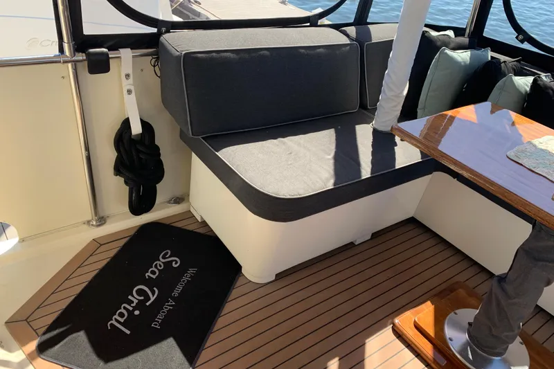 Slide: The Image of Interior of 1991 Hatteras 40 Motor Yacht with seating and wooden table. - 10