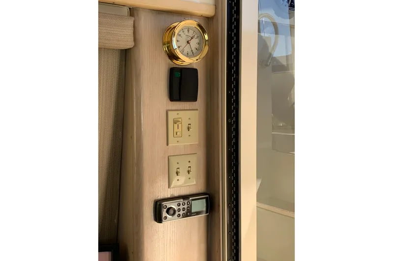 Slide: The Image of Control panel with clock and switches on 1991 Hatteras 40 Motor Yacht interior. - 101
