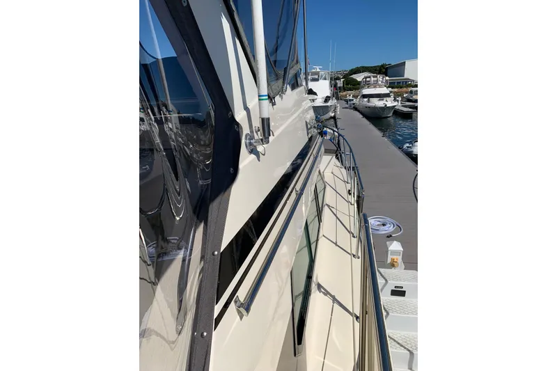Slide: The Image of 1991 Hatteras 40 Motor Yacht docked at marina, side view. - 102
