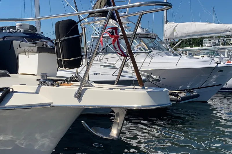 Slide: The Image of 1991 Hatteras 40 Motor Yacht docked at marina, featuring anchor and deck details. - 110
