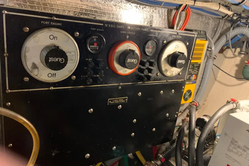 Slide: The Image of 1991 Hatteras 40 Motor Yacht engine control panel with switches and wiring. - 115
