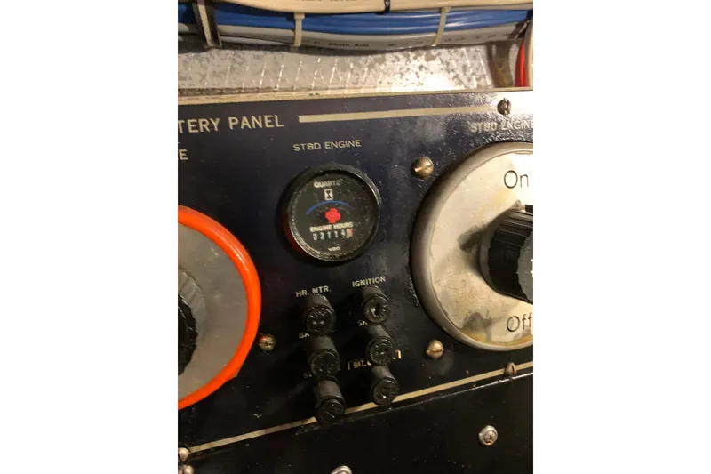 Slide: The Image of Control panel of a 1991 Hatteras 40 Motor Yacht, featuring engine hour meter and switches. - 117