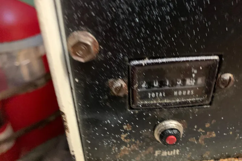 Slide: The Image of Close-up of a 1991 Hatteras 40 Motor Yacht engine hour meter and fault button. - 119