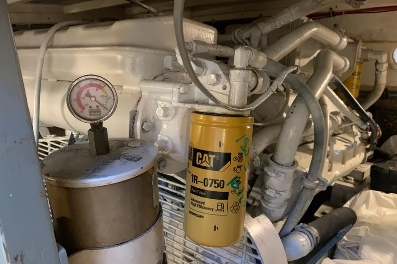 Slide: The Image of Engine room of 1991 Hatteras 40 Motor Yacht with CAT fuel filter and gauge. - 121
