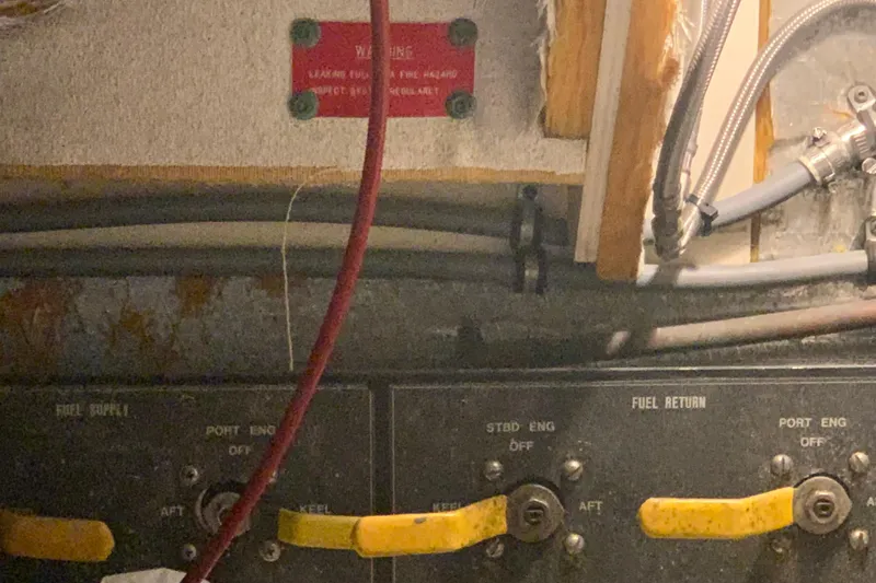 Slide: The Image of Control panel of a 1991 Hatteras 40 Motor Yacht engine room with fuel supply and return valves. - 122