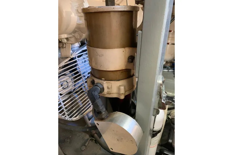 Slide: The Image of Engine component of a 1991 Hatteras 40 Motor Yacht, featuring a cylindrical filter. - 124