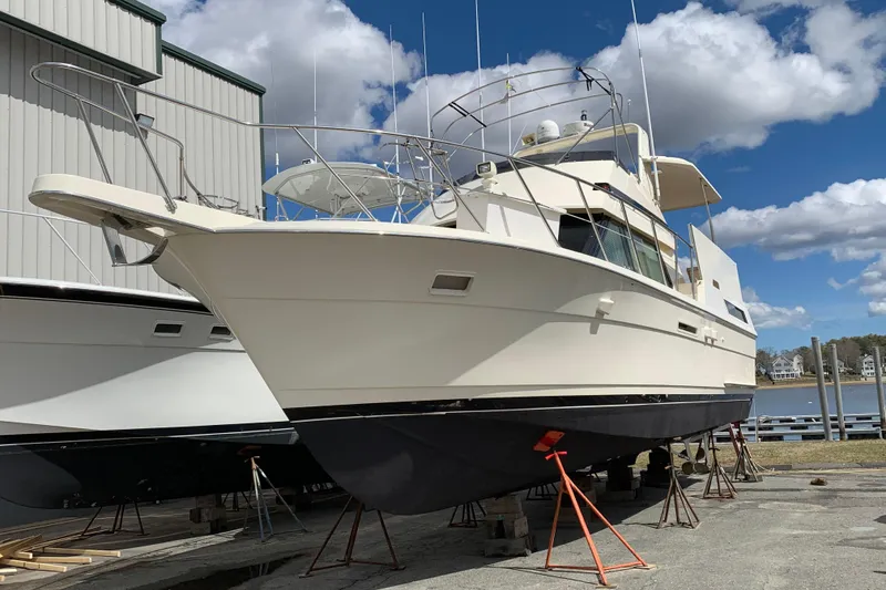 Slide: The Image of 1991 Hatteras 40 Motor Yacht on dry dock under a blue sky. - 130