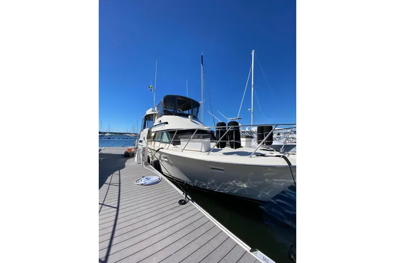Slide: The Image of 1991 Hatteras 40 Motor Yacht docked under clear blue sky. - 14