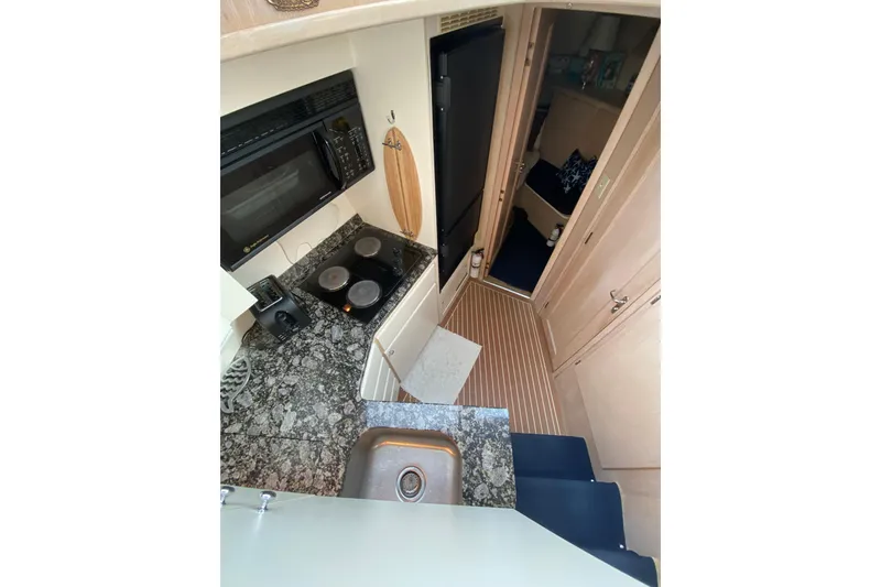 Slide: The Image of Interior of 1991 Hatteras 40 Motor Yacht kitchen with granite countertops and appliances. - 19