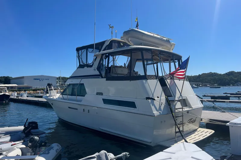 Slide: The Image of 1991 Hatteras 40 Motor Yacht docked at marina with American flag. - 2