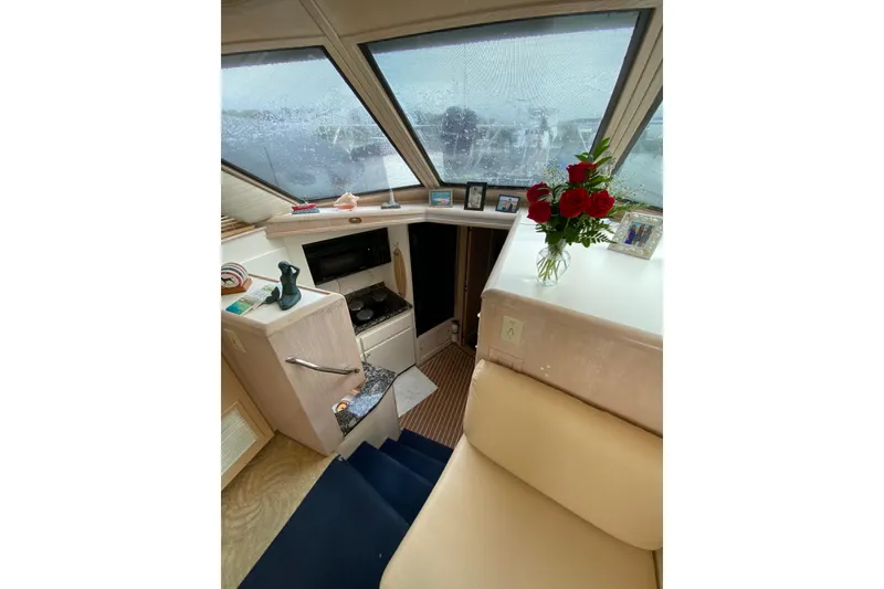 Slide: The Image of Interior of 1991 Hatteras 40 Motor Yacht with cozy seating and decorative elements. - 20