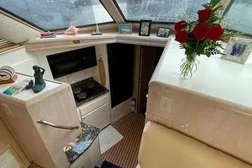 Slide: The Image of Interior of 1991 Hatteras 40 Motor Yacht with kitchen and floral decor. - 21