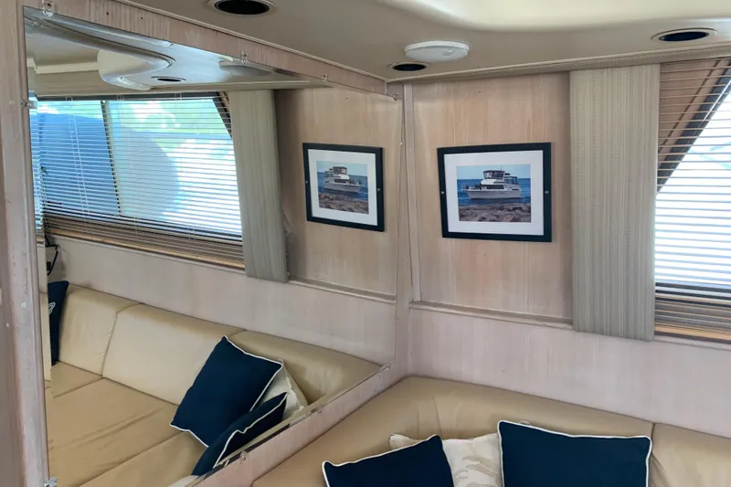 Slide: The Image of Interior of 1991 Hatteras 40 Motor Yacht with beige seating and nautical decor. - 26
