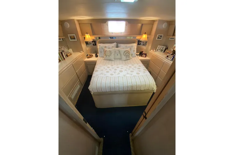 Slide: The Image of Cozy bedroom in 1991 Hatteras 40 Motor Yacht with elegant decor and soft lighting. - 33